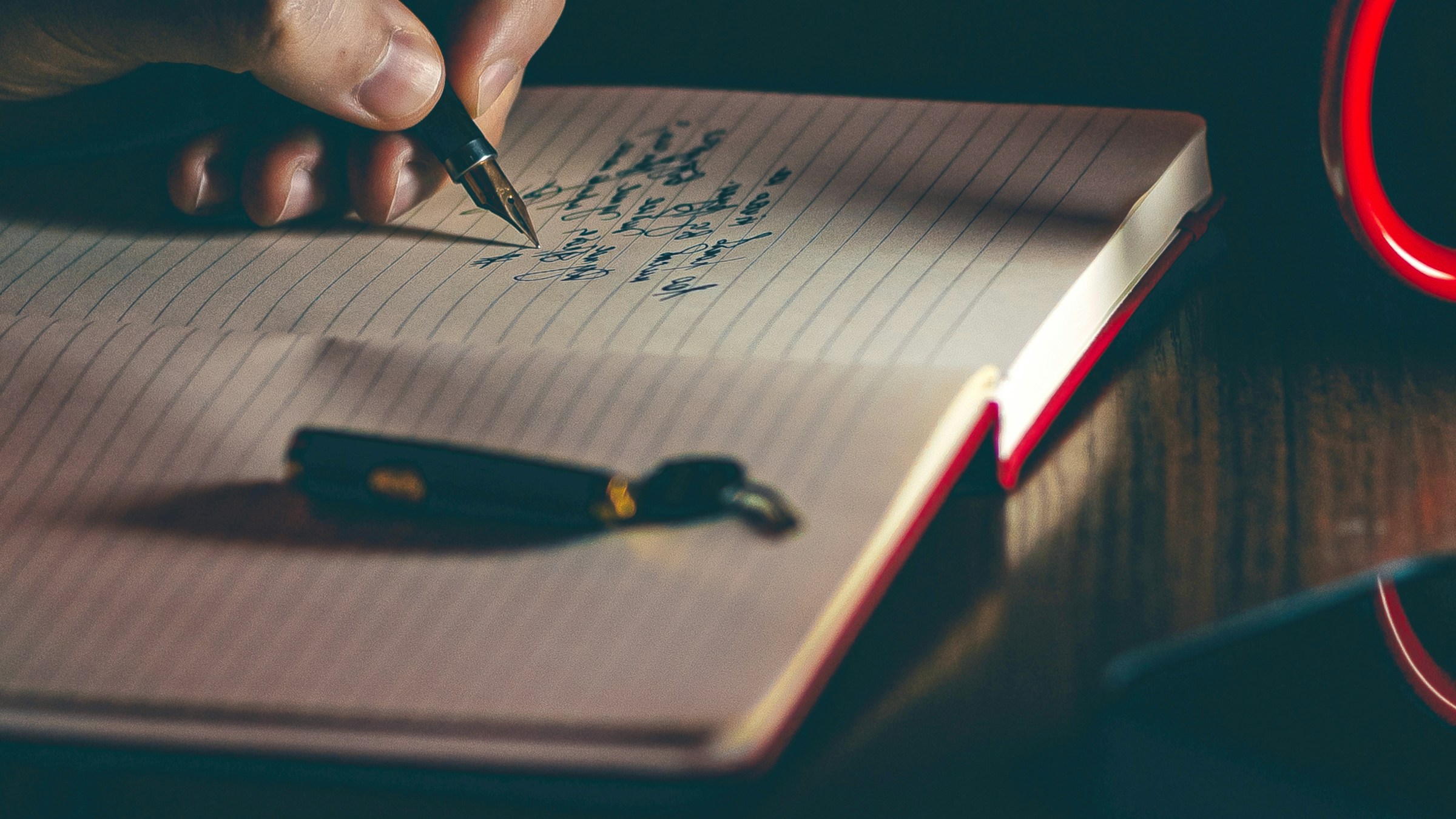 An author writing notes for a manuscript